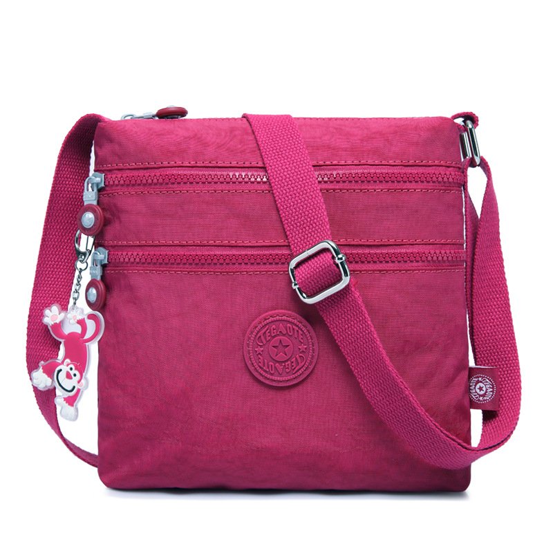 Sac bandoulière fuchsia léger multi-poches pour femme